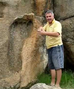 man with giant fossil footprint
